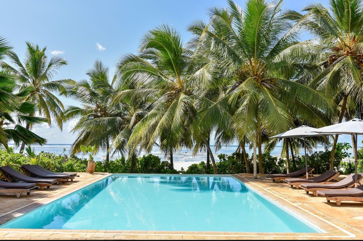 Pool through coconut palms looking directly to the Indian Ocean